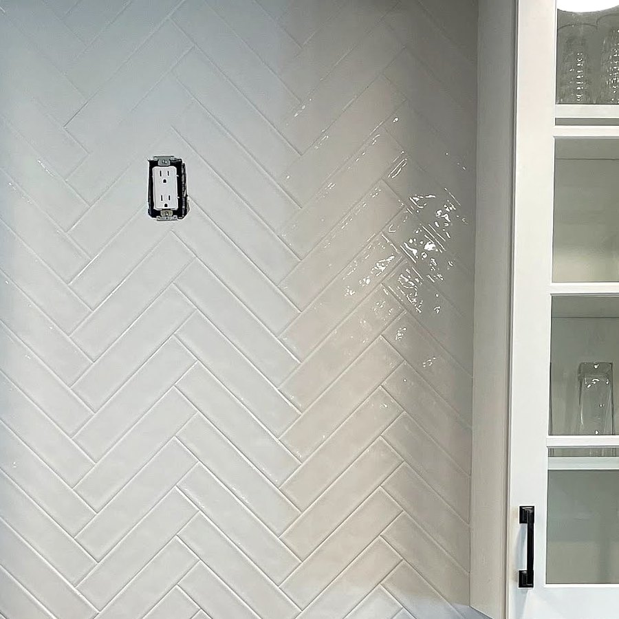 Close-up of a white herringbone backsplash