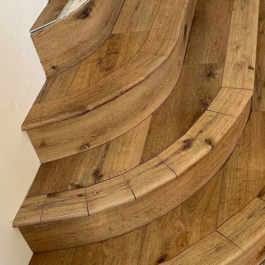 Close-up of curved stair treads clad in wood-look planks