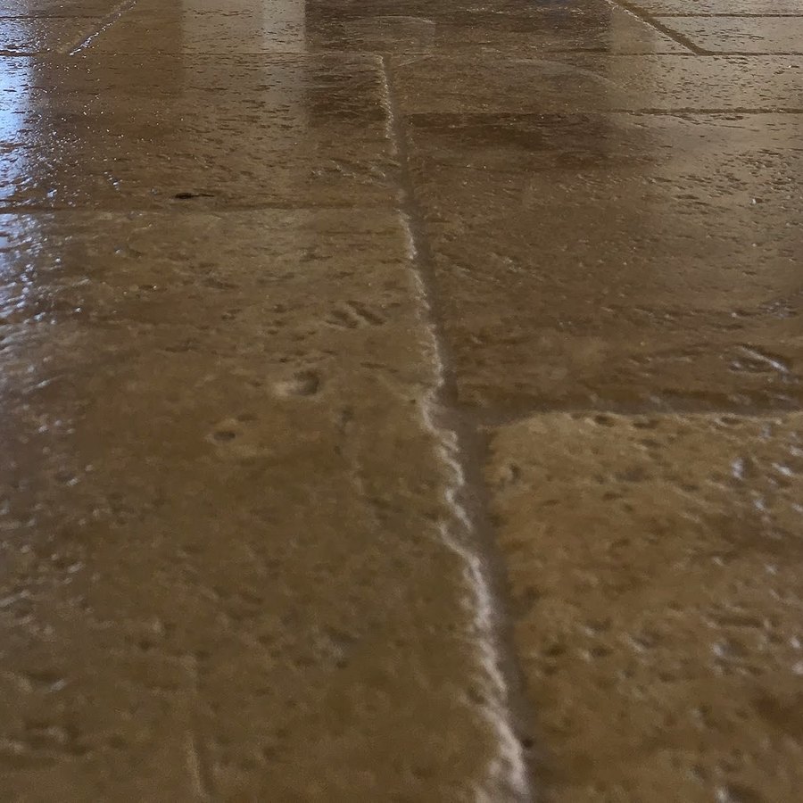 Close-up of a polished travertine tile floor