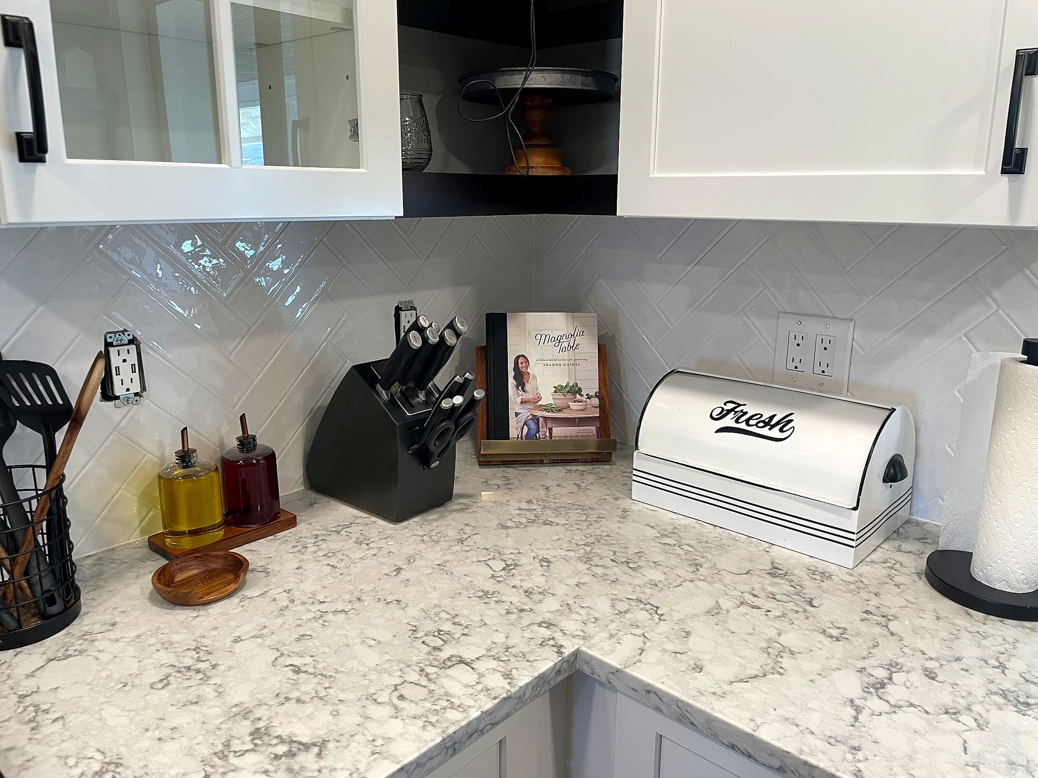 White herringbone backsplash over a marble-look counter