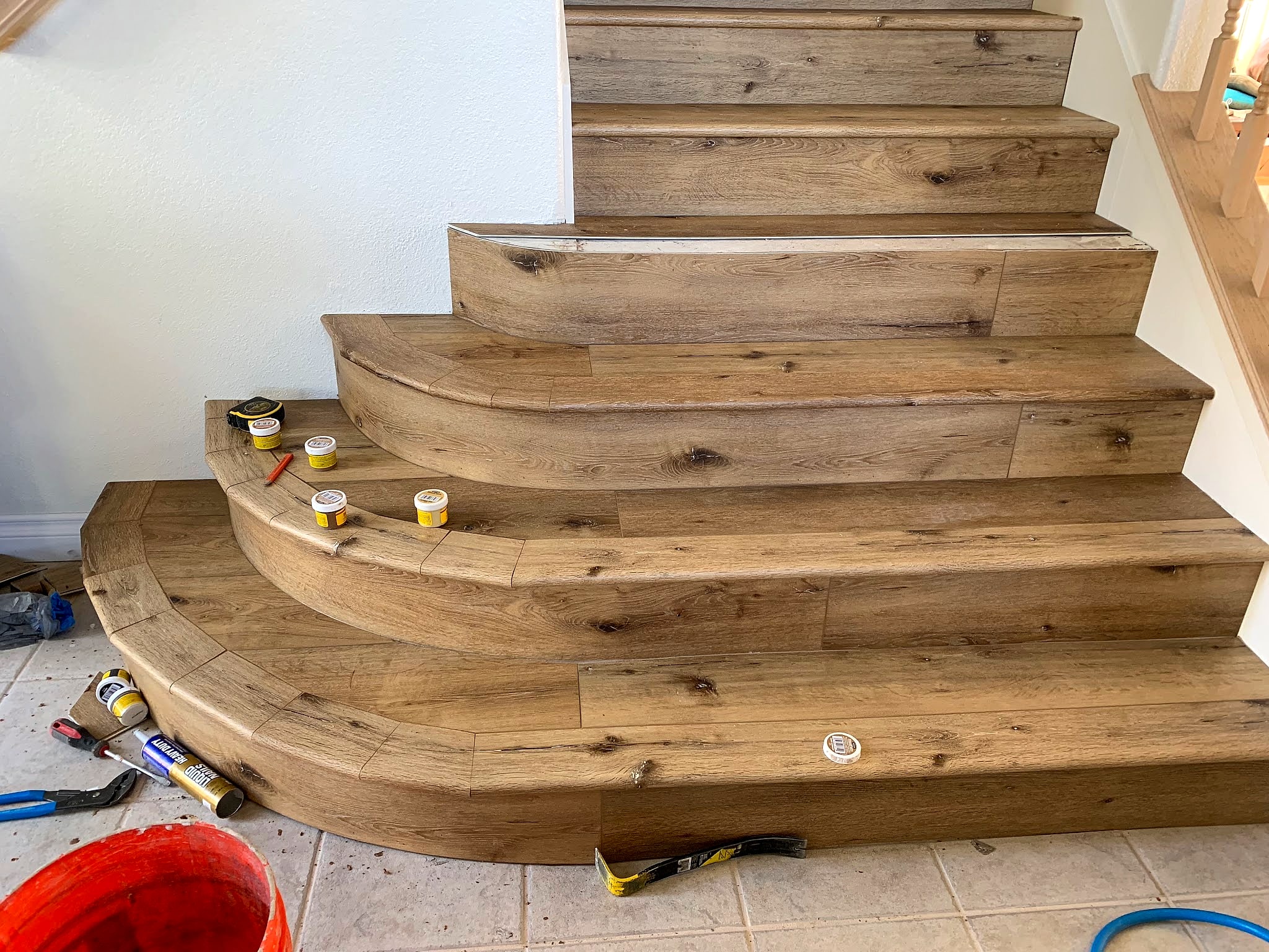 Curved stairs mid-job with tools on the floor
