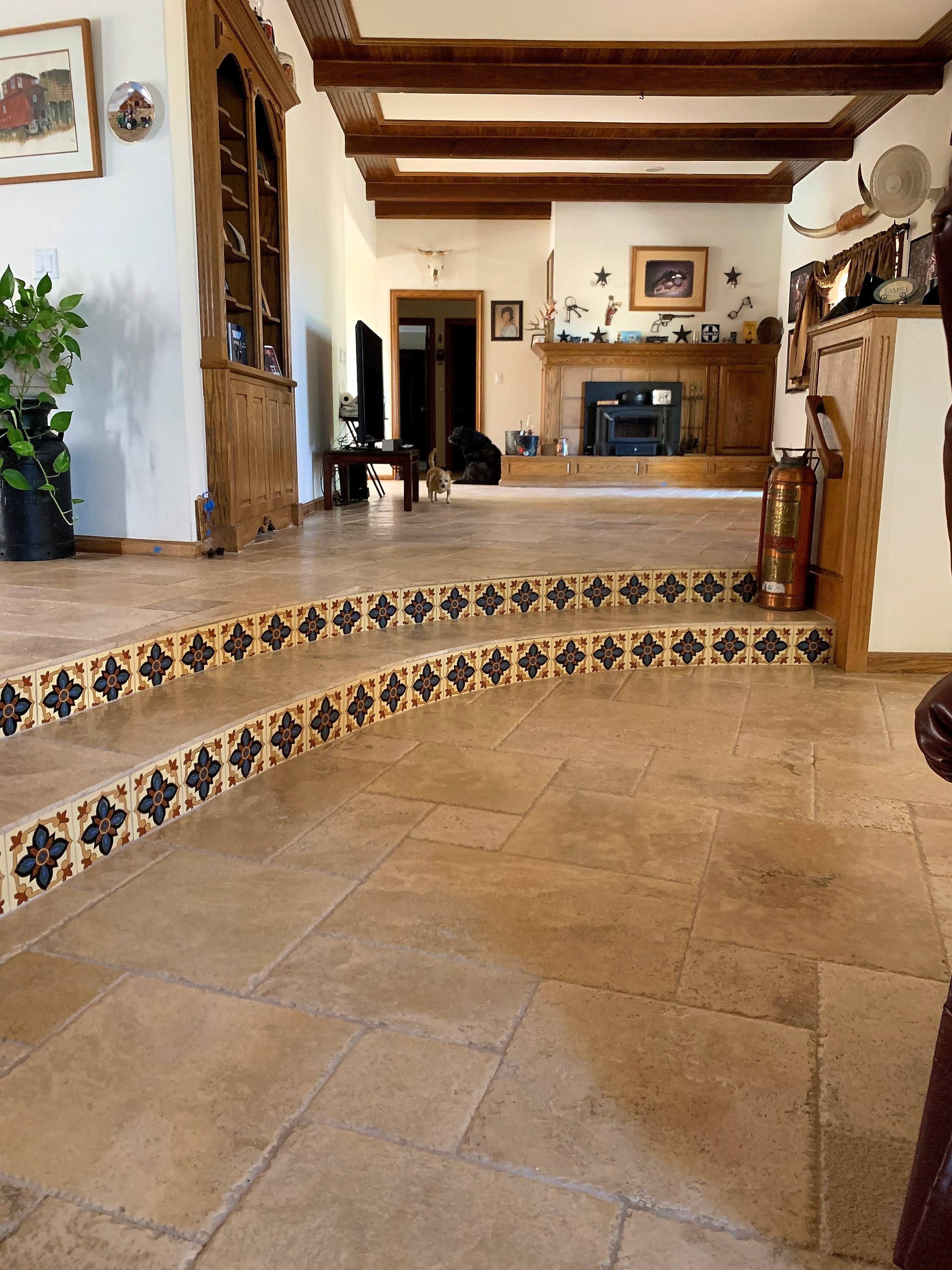 Travertine floor with patterned tile risers on the steps