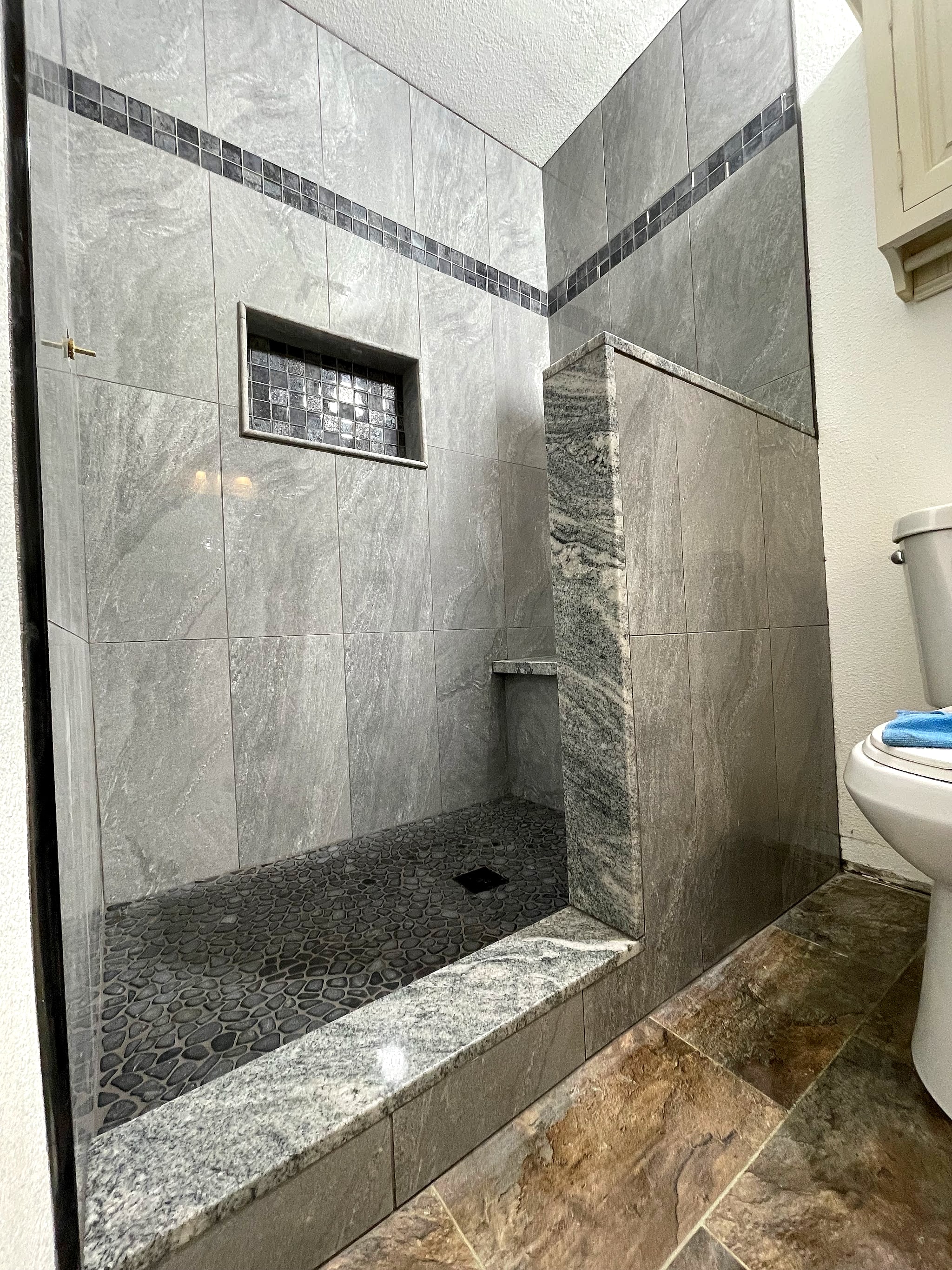 Tiled walk-in shower with a niche